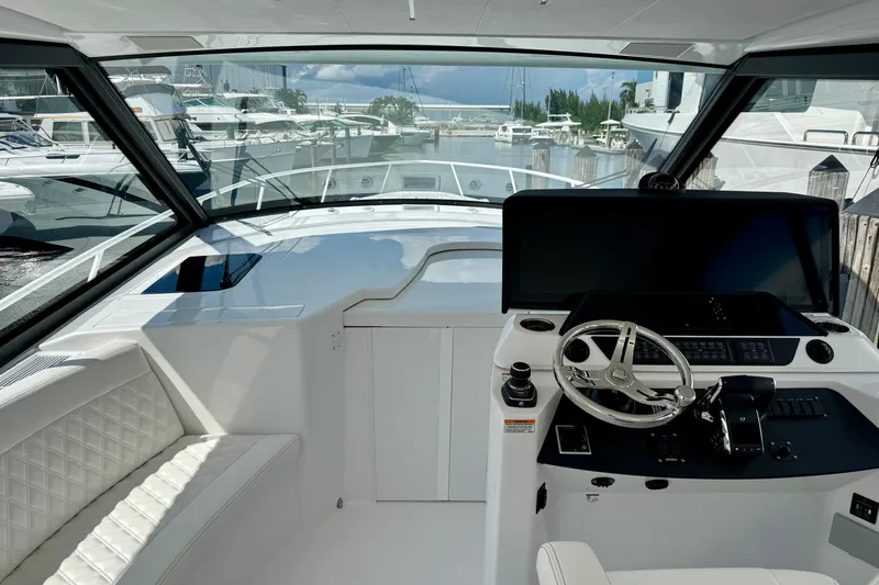  Yacht Photos Pics Interior view of 2026 Intrepid 50 Evolution yacht cockpit with modern steering and controls.