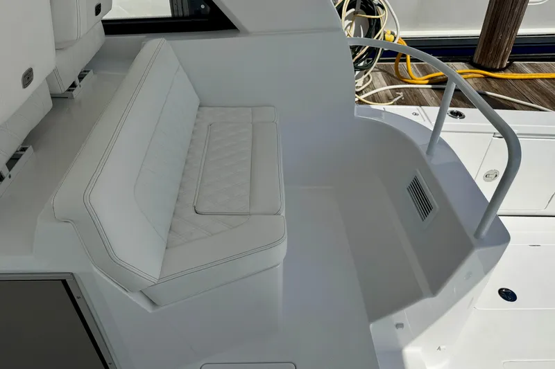  Yacht Photos Pics Luxurious seating area on 2026 Intrepid 50 Evolution yacht, featuring white upholstery and sleek design.