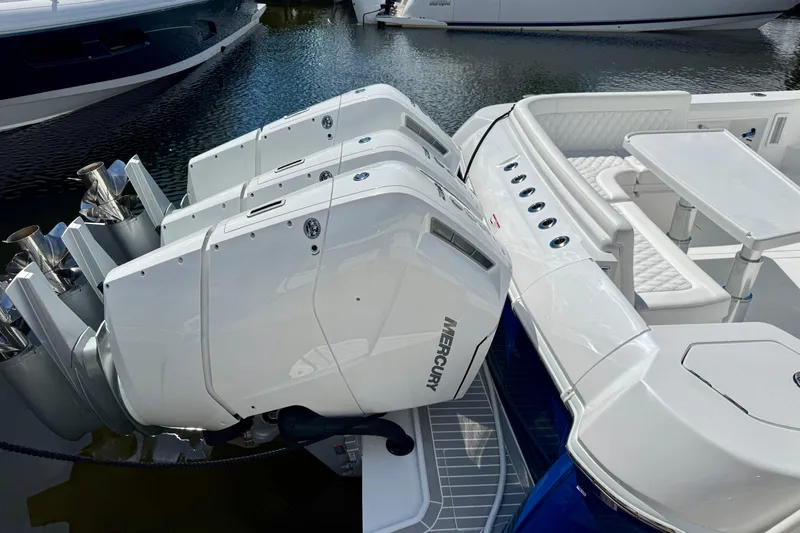  Yacht Photos Pics 2026 Intrepid 50 Evolution boat with powerful Mercury outboard engines docked in marina.