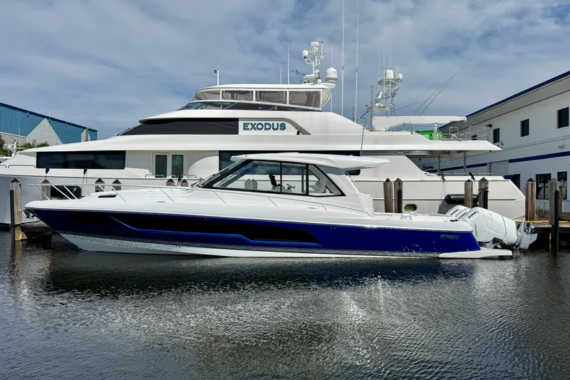  Yacht Photos Pics 2026 Intrepid 50 Evolution yacht docked beside a larger vessel.