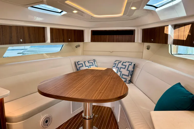 Yacht Photos Pics Luxurious interior of 2026 Intrepid 50 Evolution yacht with elegant seating and wooden table.