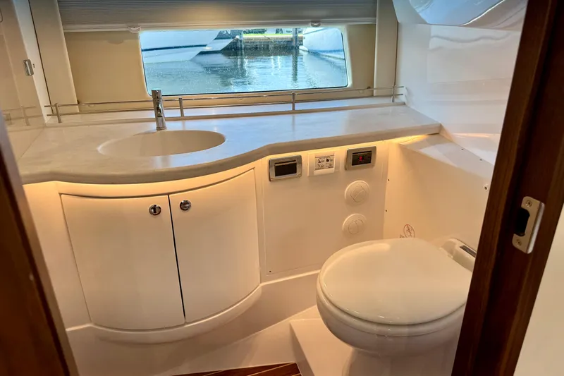 Yacht Photos Pics Luxurious bathroom interior of 2026 Intrepid 50 Evolution yacht with modern fixtures and window view.
