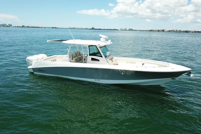  Yacht Photos Pics 2016 Boston Whaler 370 Outrage boat on calm water under a clear sky.