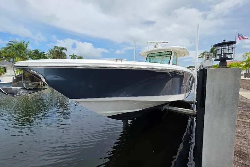  Yacht Photos Pics 2016 Boston Whaler 370 Outrage boat docked, featuring sleek design and modern amenities.