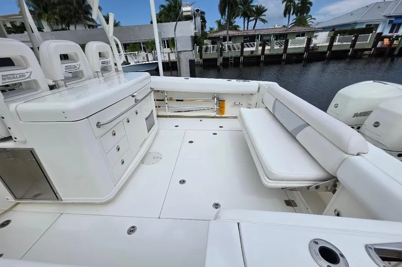  Yacht Photos Pics 2016 Boston Whaler 370 Outrage boat interior with seating and storage, docked by waterfront homes.