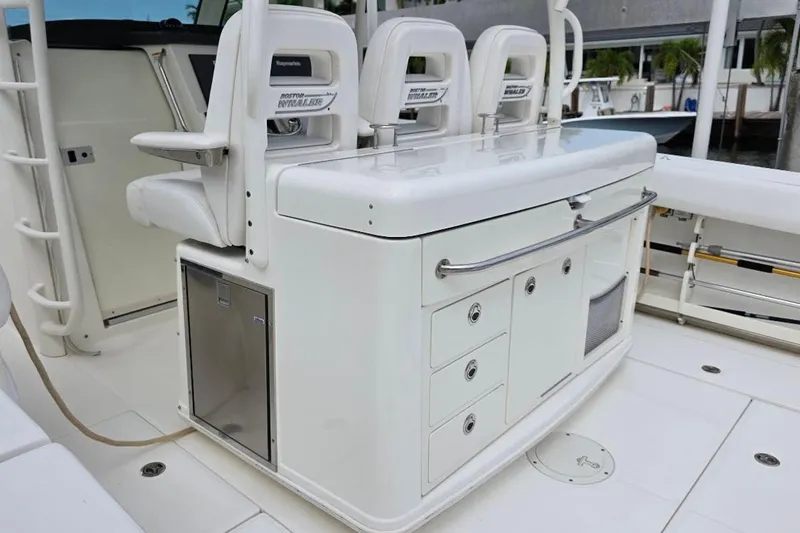  Yacht Photos Pics 2016 Boston Whaler 370 Outrage boat interior with seating and storage compartments.