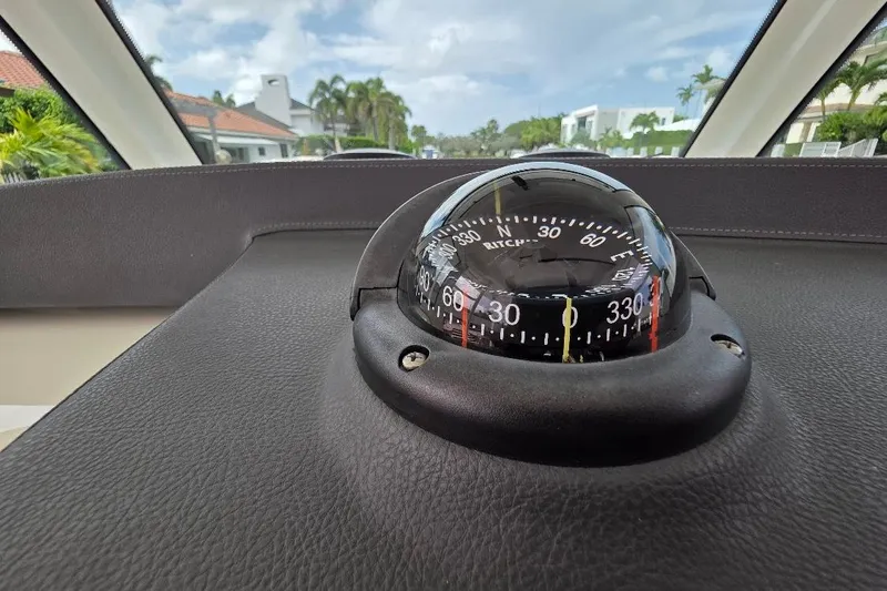  Yacht Photos Pics Compass on 2016 Boston Whaler 370 Outrage dashboard, with scenic background.