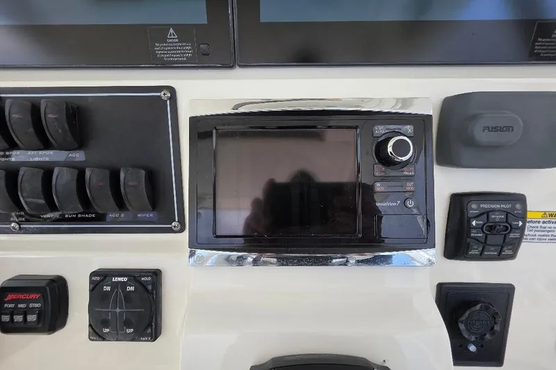  Yacht Photos Pics Control panel of a 2016 Boston Whaler 370 Outrage boat with various switches and displays.