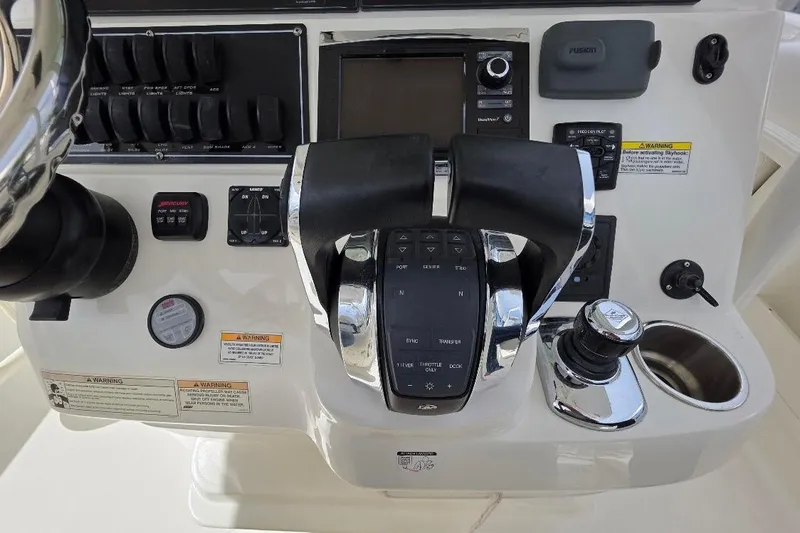  Yacht Photos Pics Control panel of a 2016 Boston Whaler 370 Outrage boat with throttle and navigation controls.