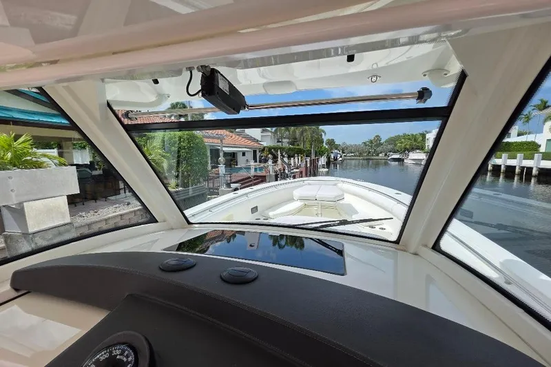  Yacht Photos Pics Interior view from a 2016 Boston Whaler 370 Outrage, overlooking a serene waterfront.