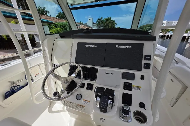  Yacht Photos Pics Helm of 2016 Boston Whaler 370 Outrage with Raymarine displays and Mercury controls.