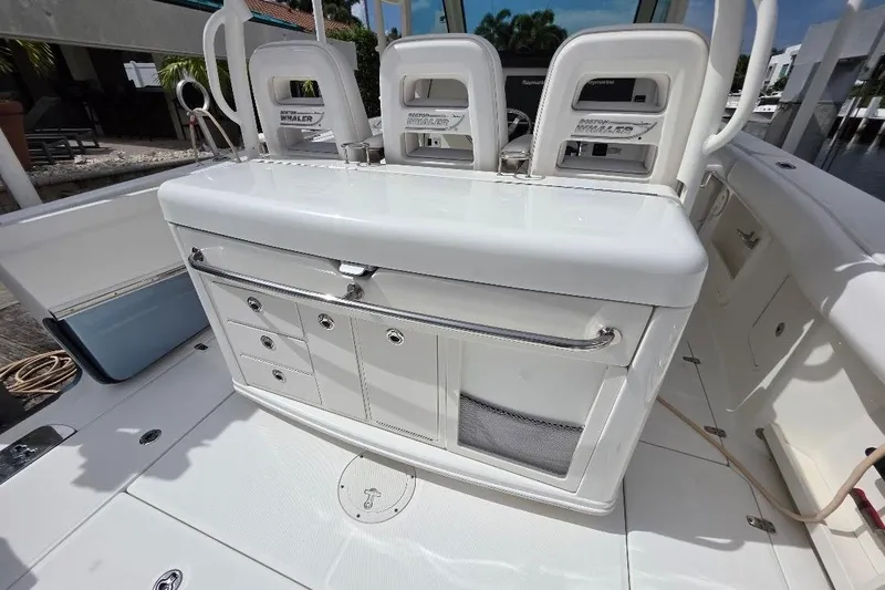 Yacht Photos Pics 2016 Boston Whaler 370 Outrage boat interior with storage compartments and seating.