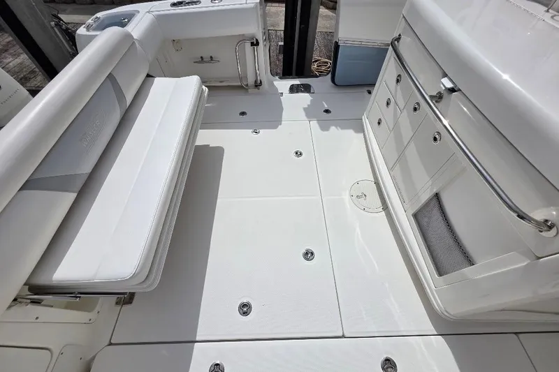  Yacht Photos Pics 2016 Boston Whaler 370 Outrage interior with white seating and storage compartments.