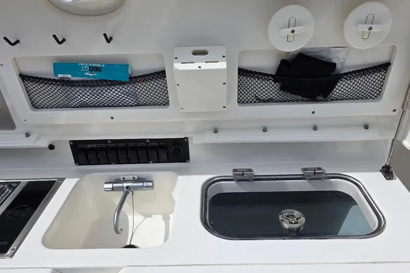  Yacht Photos Pics 2016 Boston Whaler 370 Outrage boat interior with storage compartments and control panel.