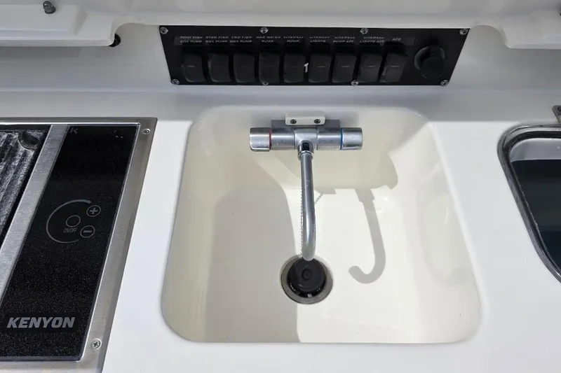  Yacht Photos Pics Boston Whaler 370 Outrage 2016 boat sink and control panel with Kenyon cooktop.