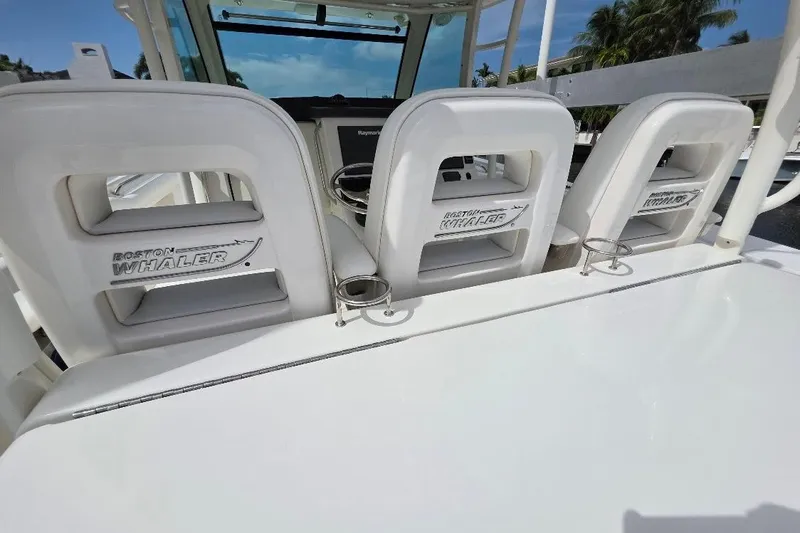  Yacht Photos Pics 2016 Boston Whaler 370 Outrage boat seats with logo, featuring cup holders.