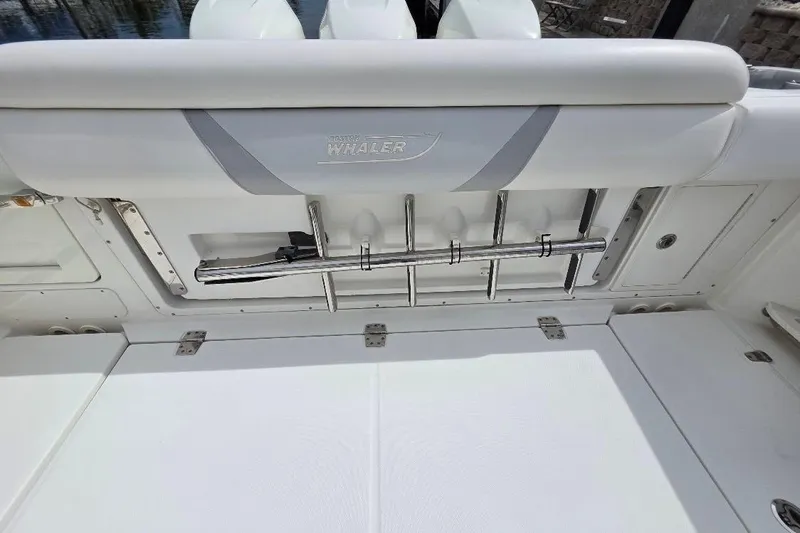  Yacht Photos Pics 2016 Boston Whaler 370 Outrage boat interior with rod holders and cushioned seating.