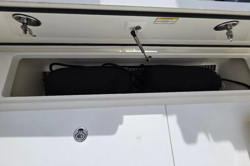  Yacht Photos Pics Storage compartment on a 2016 Boston Whaler 370 Outrage boat, featuring secure latches.