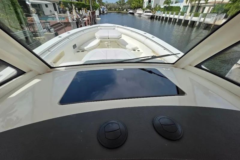  Yacht Photos Pics 2016 Boston Whaler 370 Outrage boat interior view from helm, docked in canal.