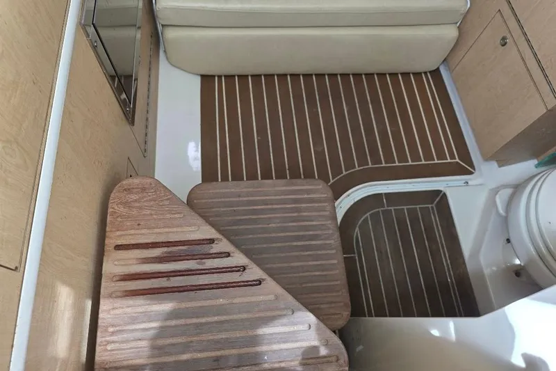  Yacht Photos Pics 2016 Boston Whaler 370 Outrage interior with wooden flooring and seating area.