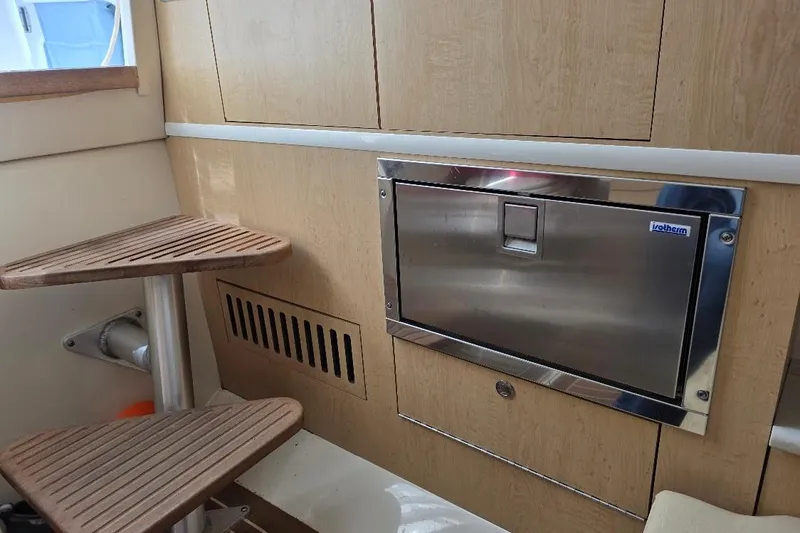  Yacht Photos Pics Interior of 2016 Boston Whaler 370 Outrage with wooden steps and stainless steel appliance.