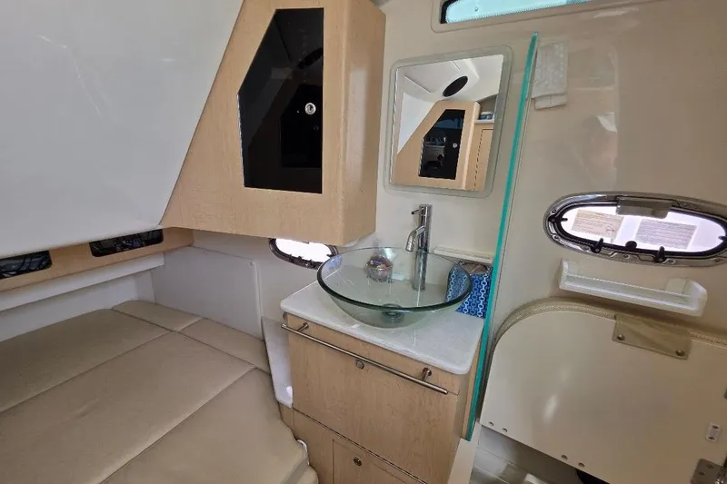  Yacht Photos Pics Interior of 2016 Boston Whaler 370 Outrage, featuring a modern sink and cozy seating area.