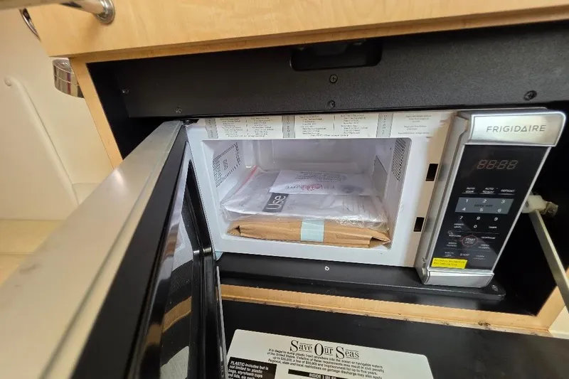  Yacht Photos Pics Frigidaire microwave inside 2016 Boston Whaler 370 Outrage boat, with items stored inside.