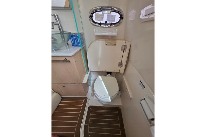  Yacht Photos Pics 2016 Boston Whaler 370 Outrage bathroom with modern fixtures and wooden flooring.