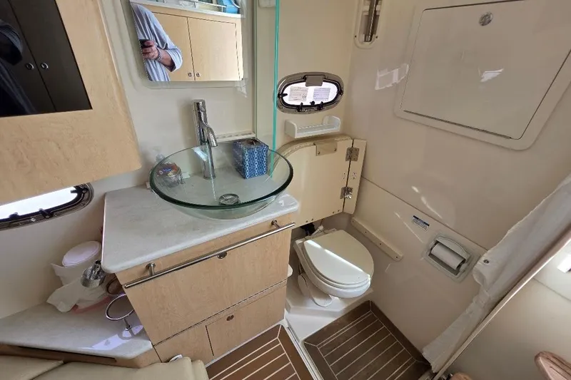  Yacht Photos Pics 2016 Boston Whaler 370 Outrage bathroom with modern sink and compact toilet.