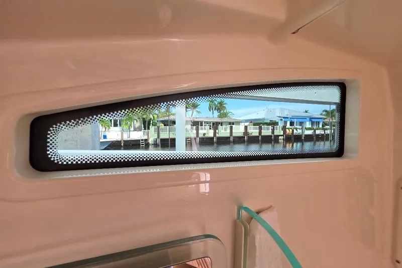  Yacht Photos Pics Interior view from 2016 Boston Whaler 370 Outrage, showcasing window and waterfront scenery.