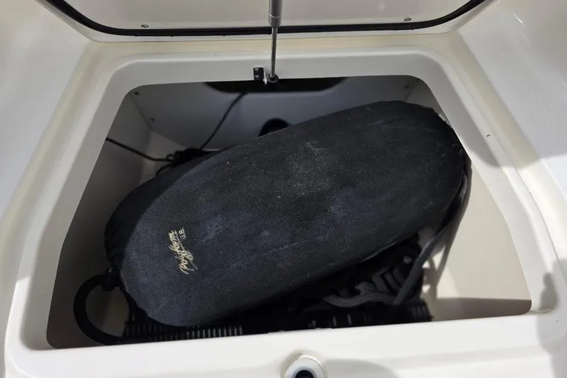 Yacht Photos Pics Storage compartment in a 2016 Boston Whaler 370 Outrage boat, containing a black fender.