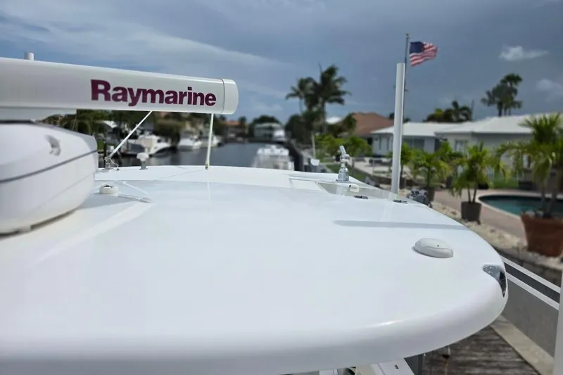  Yacht Photos Pics 2016 Boston Whaler 370 Outrage with Raymarine equipment, docked near waterfront homes.