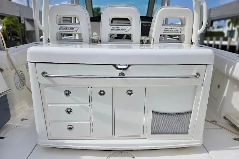  Yacht Photos Pics 2016 Boston Whaler 370 Outrage boat interior with storage compartments and seating.
