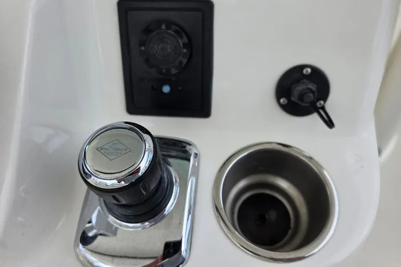  Yacht Photos Pics Control panel of a 2016 Boston Whaler 370 Outrage boat, featuring joystick and cup holder.