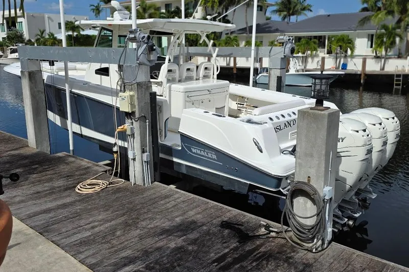  Yacht Photos Pics 2016 Boston Whaler 370 Outrage docked, featuring triple Mercury outboard engines.
