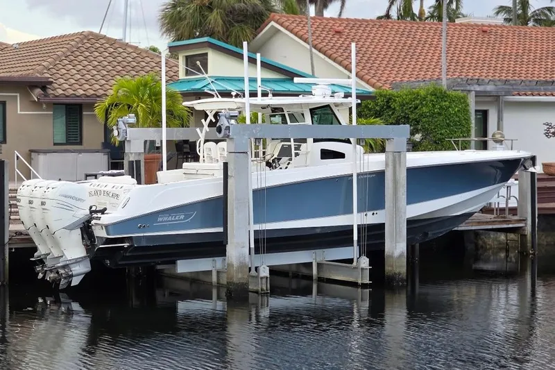  Yacht Photos Pics 2016 Boston Whaler 370 Outrage boat docked near waterfront homes.