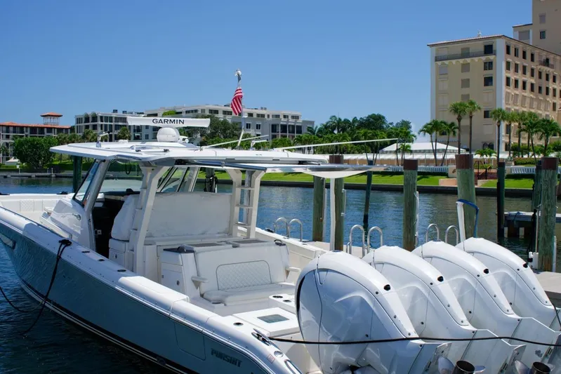 W7 Yacht Photos Pics 2022 Pursuit S 428 Sport boat docked with four engines, waterfront view.