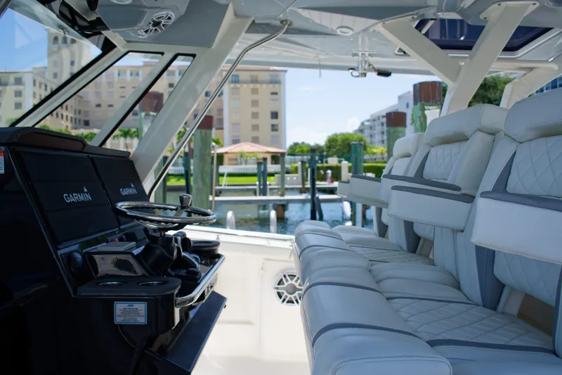 W7 Yacht Photos Pics Interior of 2022 Pursuit S 428 Sport boat with luxurious seating and Garmin navigation.