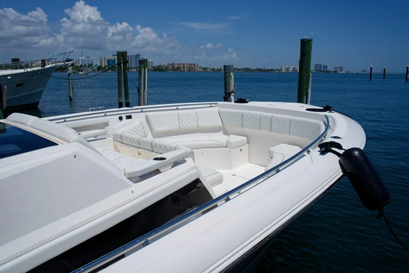 W7 Yacht Photos Pics 2022 Pursuit S 428 Sport boat docked with luxurious seating and ocean view.
