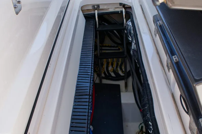 W7 Yacht Photos Pics 2022 Pursuit S 428 Sport boat interior with ladder and storage compartment.
