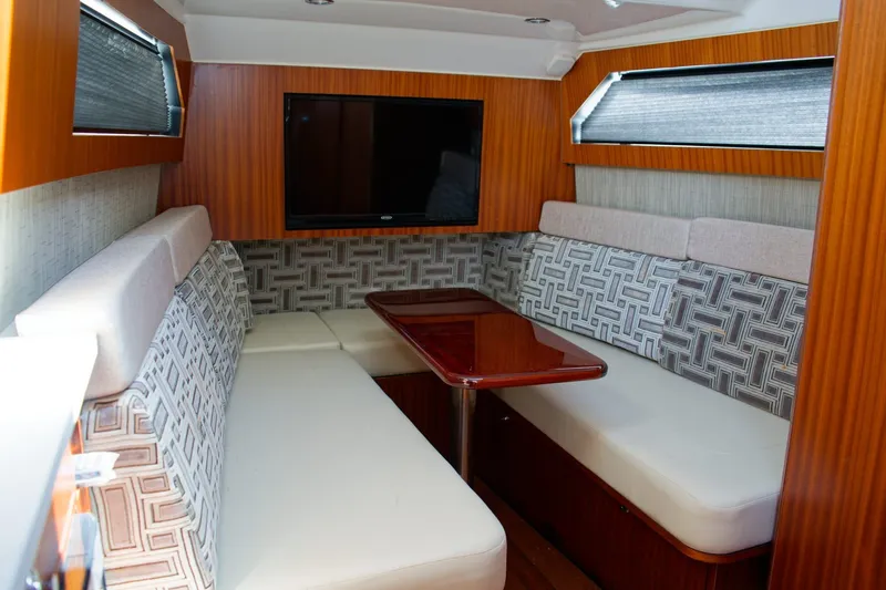 W7 Yacht Photos Pics Luxurious interior of 2022 Pursuit S 428 Sport boat with cozy seating and TV.