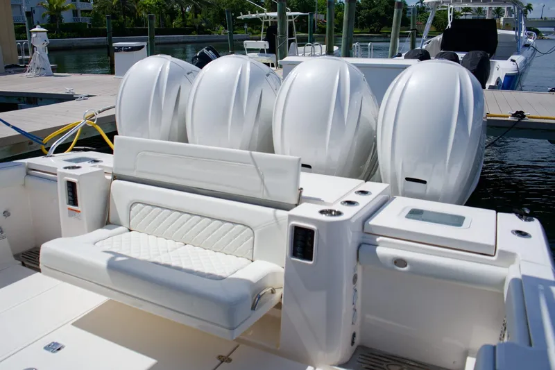 W7 Yacht Photos Pics 2022 Pursuit S 428 Sport boat with four powerful outboard engines docked at marina.