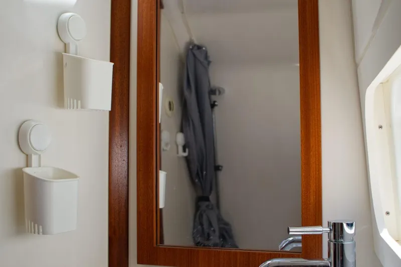 W7 Yacht Photos Pics Bathroom interior of 2022 Pursuit S 428 Sport boat with mirror and storage.