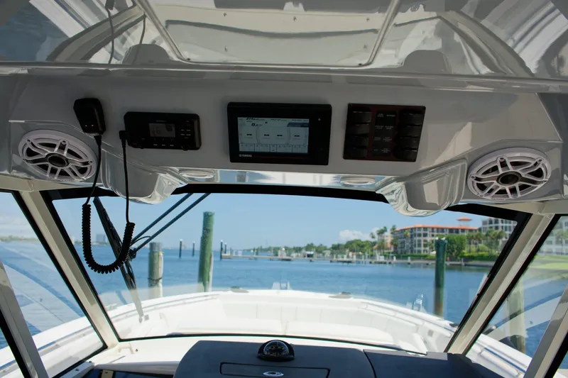 W7 Yacht Photos Pics Interior view of 2022 Pursuit S 428 Sport boat dashboard with electronics and speakers.