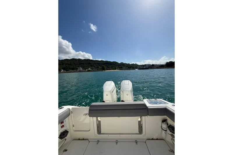  Yacht Photos Pics 2024 Boston Whaler 280 Outrage on water, showcasing dual engines and scenic coastline.