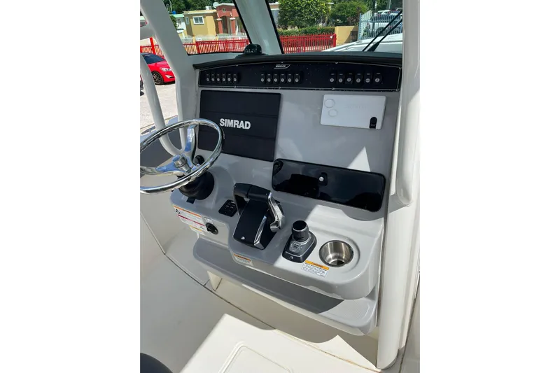  Yacht Photos Pics 2024 Boston Whaler 280 Outrage helm with Simrad electronics and steering wheel.