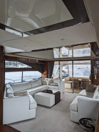  Yacht Photos Pics Luxurious interior of 2010 Princess 72 Motor Yacht with white seating and large windows.