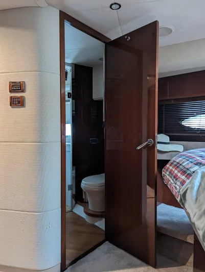  Yacht Photos Pics Interior of 2010 Princess 72 Motor Yacht with open bathroom door and bedroom view.