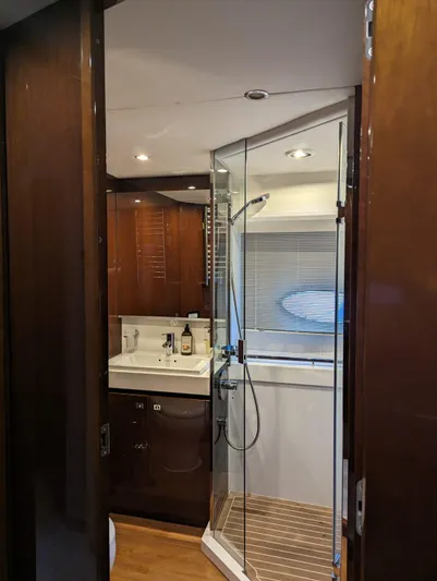  Yacht Photos Pics Luxurious bathroom in 2010 Princess 72 Motor Yacht with glass shower and wooden cabinetry.