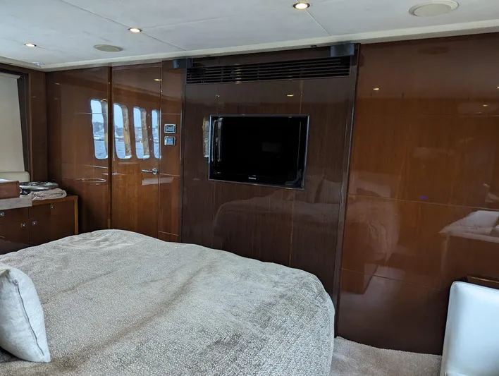  Yacht Photos Pics Luxurious interior of 2010 Princess 72 Motor Yacht with TV and plush bedding.